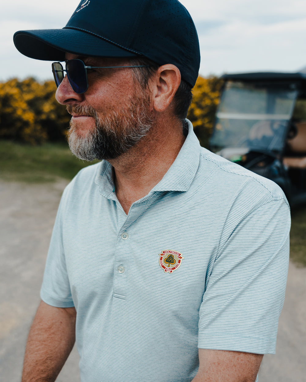 A golfer in a Holywood golf club polo